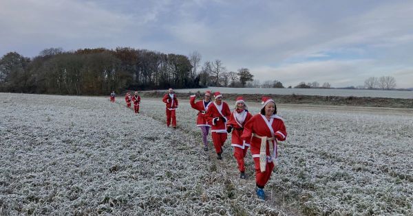 Ramblers dressed as Santa in the snow